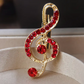 Gold Treble Clef Pin with Red Rhinestones