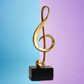 Large Golden Treble Clef Musical Note Statue on Black Base