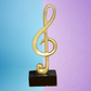 Large Golden Treble Clef Musical Note Statue on Black Base