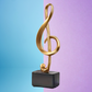 Large Golden Treble Clef Musical Note Statue on Black Base